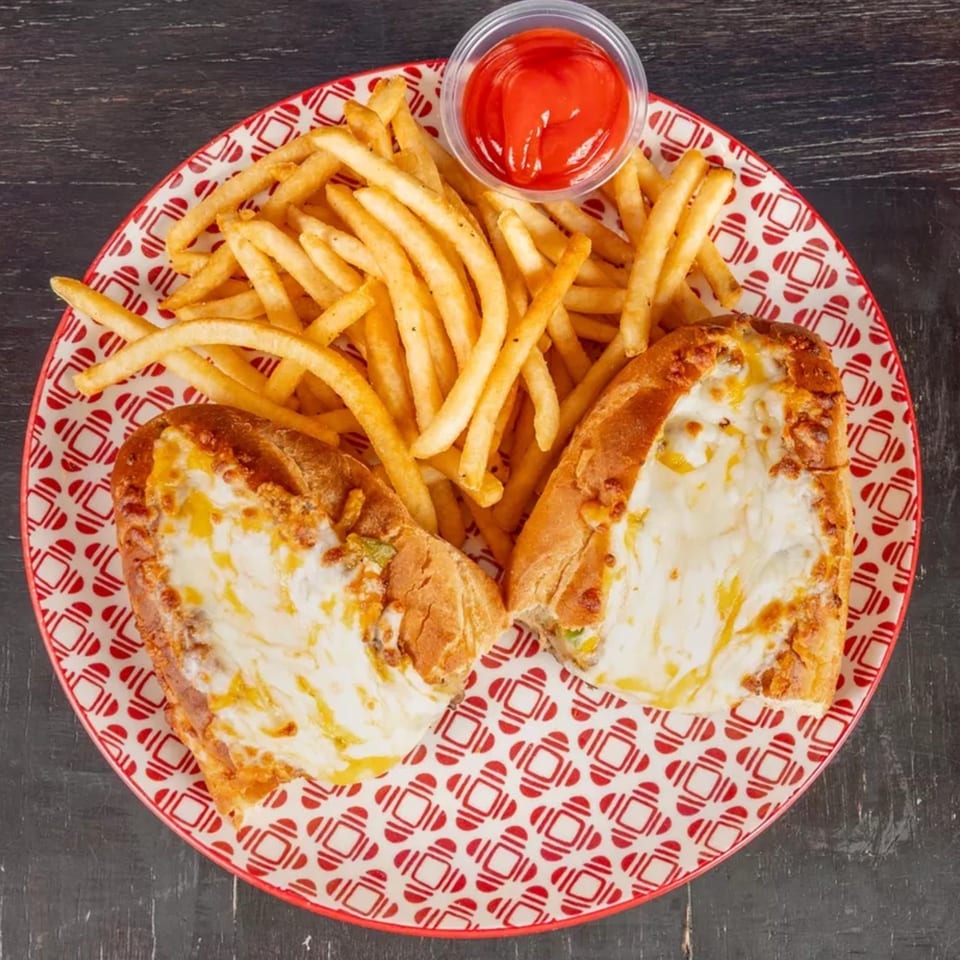 Two cheesy bread boats with a side of golden fries and a small cup of ketchup on a red and white plate.
